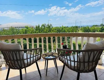 two chairs and a table on a balcony at Apartment Topolica in Bar