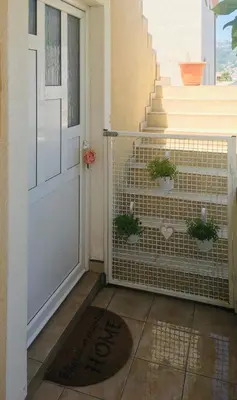 a porch with a door with potted plants on it at Apartment Topolica in Bar