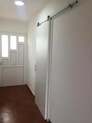 a room with a white wall with a sliding door at Apartment Topolica in Bar
