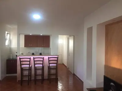 a kitchen with two bar stools in a room at Apartment Topolica in Bar