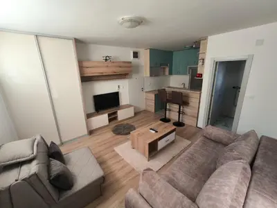 a living room with a couch and a table at Stex Signature Central Point in Podgorica