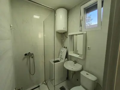 a bathroom with a shower and a toilet and a sink at Stex Signature Central Point in Podgorica
