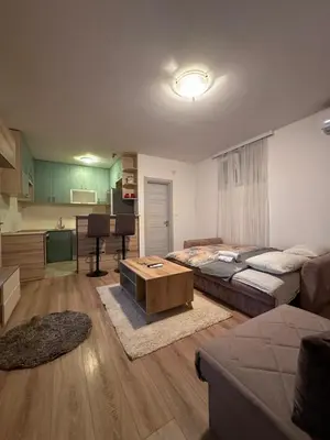 a living room with a couch and a table at Stex Signature Central Point in Podgorica