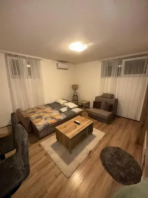 a living room with a bed and a coffee table at Stex Signature Central Point in Podgorica