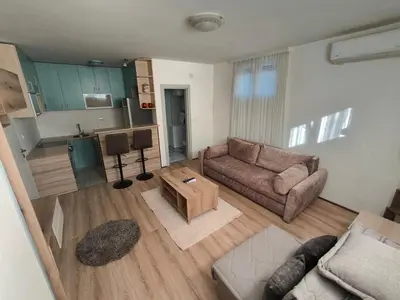 a living room with a couch and a table at Stex Signature Central Point in Podgorica