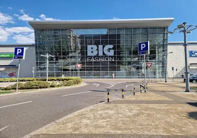a large building with a big sign on it at Stex Signature Central Point in Podgorica