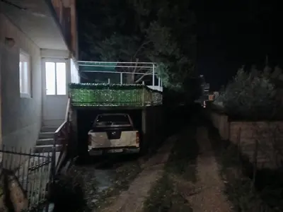 a car parked next to a house at night at Apartman sa garažom in Sutomore