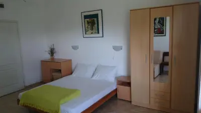 a small bedroom with a bed and a cabinet at Luce di Sole Apartment in Ulcinj