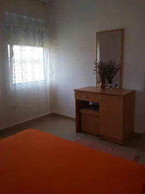 a room with a mirror and a dresser with a dresser at Luce di Sole Apartment in Ulcinj