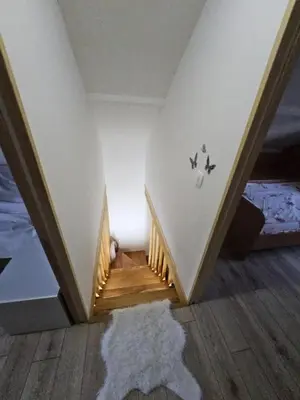 a stairway in a room with a bed and a rug at Village Drago in Cetinje
