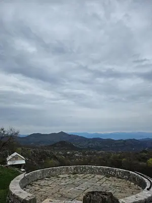 a stone bench with a view of the mountains at Village Drago in Cetinje