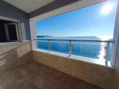 a large bathroom with a view of the ocean at Apartmani Šaltić in Sutomore