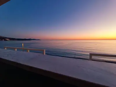 a view of the ocean at sunset from a boat at Apartmani Šaltić in Sutomore