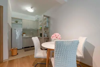 a kitchen and dining room with a table and chairs at Apartment Pržno See View in Pržno