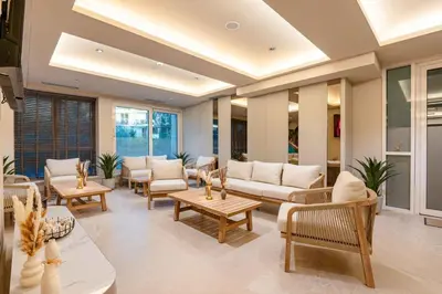 a living room with couches and tables and windows at Apartment Pržno See View in Pržno