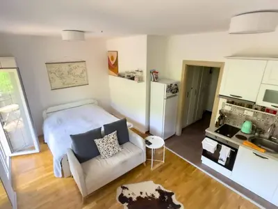 a living room with a bed and a couch at Pela's Apartment in Budva