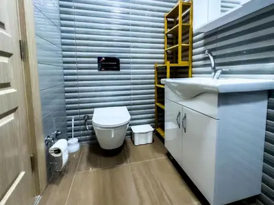 a small bathroom with a toilet and a sink at Pela's Apartment in Budva