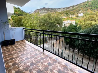 a balcony with a view of a mountain at Pela's Apartment in Budva