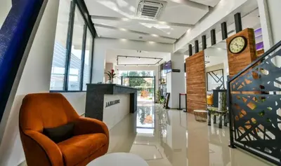 a lobby with a chair and a clock on the wall at Hotel Lajka Luxury in Ulcinj