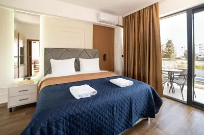 a bedroom with a bed with two towels on it at Hotel Lajka Luxury in Ulcinj
