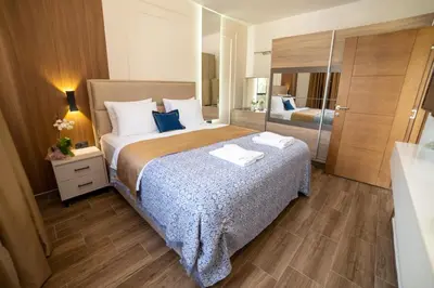 a hotel room with a large bed and a mirror at Hotel Lajka Luxury in Ulcinj