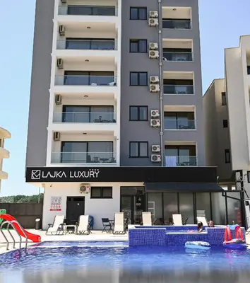 a hotel with a pool in front of a building at Hotel Lajka Luxury in Ulcinj