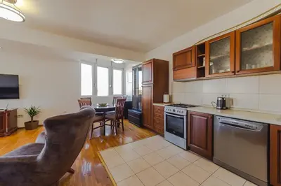 a kitchen with a table and a dining room at Sunbright Metropolitan in Podgorica