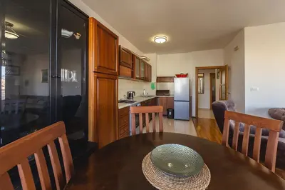 a kitchen and dining room with a table with a hat on it at Sunbright Metropolitan in Podgorica