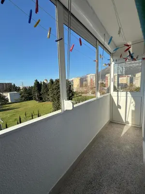 a room with windows with a view of a city at Bar Central Stay Apartment in Bar