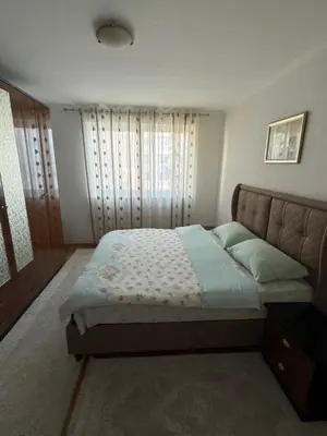 a bedroom with a bed and a large window at Bar Central Stay Apartment in Bar