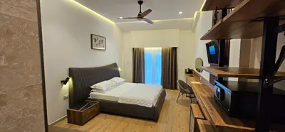 a bedroom with a bed and a desk and a television at Resort Comfort - Long Beach in Ulcinj