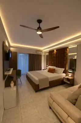 a hotel room with a large bed and a couch at Resort Comfort - Long Beach in Ulcinj