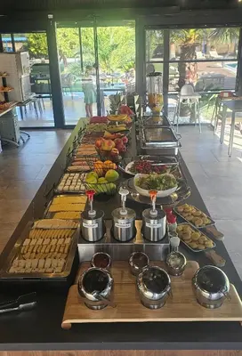 a buffet line with many different types of food at Resort Comfort - Long Beach in Ulcinj