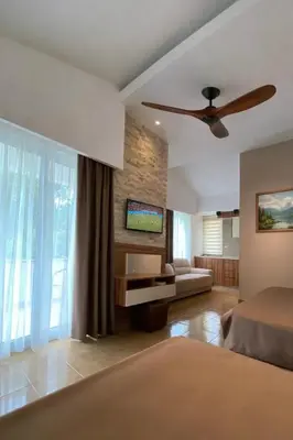 a bedroom with a bed and a ceiling fan at Resort Comfort - Long Beach in Ulcinj