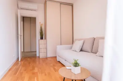 a living room with a white couch and a table at Maris View in Becici