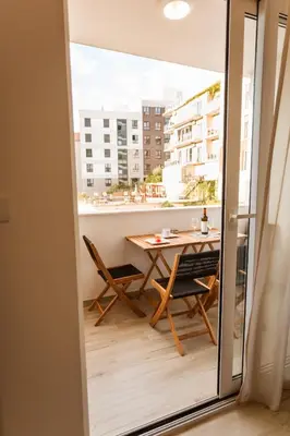 a balcony with a table and chairs and a view at Maris View in Becici