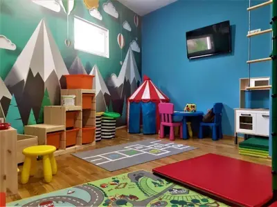 a childs play room with blue walls and mountains at Maris View in Becici