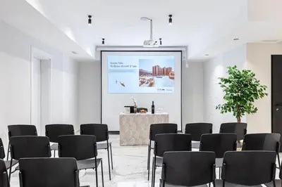 a room with a stage and chairs and a screen at Maris View in Becici