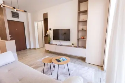 a living room with a couch and a tv at Maris View in Becici