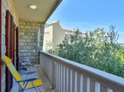 two chairs sitting on a porch with a balcony at Villa Marković 2 in Sutomore