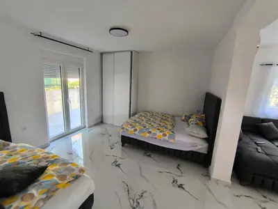 a bedroom with a bed and a couch in it at Nar in Budva