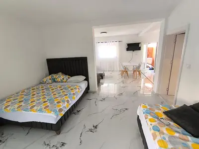 a bedroom with two beds and a marble floor at Nar in Budva