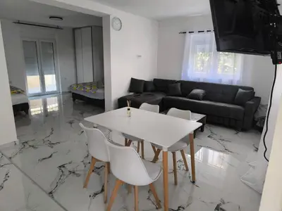 a living room with a white table and chairs at Nar in Budva