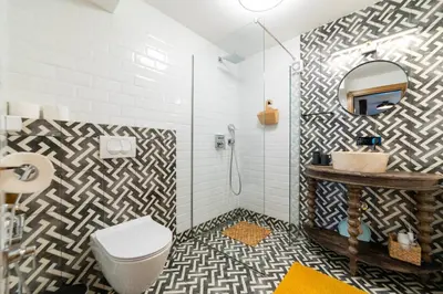 a bathroom with a toilet and a sink and a mirror at Seafront Kotor Bay View Villa NW in Muo