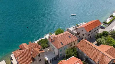 an aerial view of a building next to the water at Seafront Kotor Bay View Villa NW in Muo