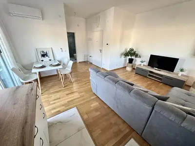a living room with a couch and a table at Alula Apartments in Bar