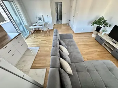 a living room with a gray couch and a table at Alula Apartments in Bar