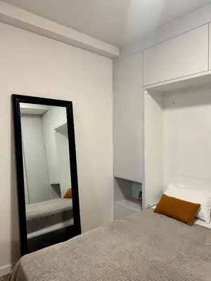 a bedroom with a mirror next to a bed at Sunny Villas Luxury Apartment with Garden and Seaview in Katun