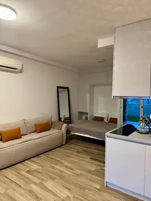 a living room with a couch and a bed at Sunny Villas Luxury Apartment with Garden and Seaview in Katun