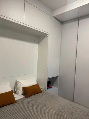 a bedroom with white walls and a bed with two pillows at Sunny Villas Luxury Apartment with Garden and Seaview in Katun
